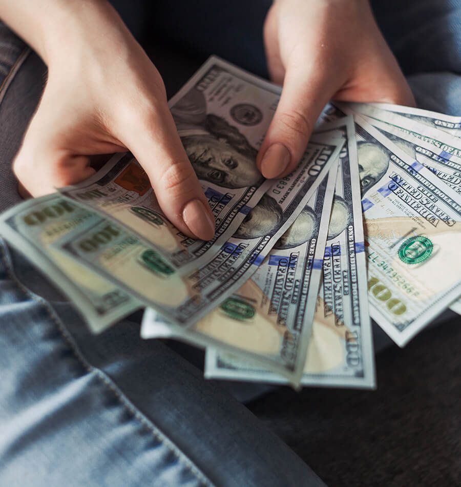 A person holding money in their hands